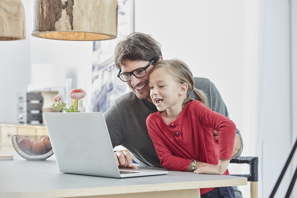 Dad helping child with homework online